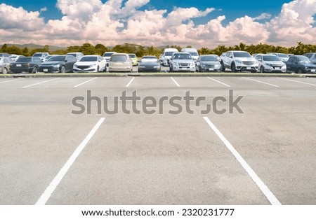 Wide empty asphalt parking lot background. with many cars parked background. outdoor empty space parking lot with trees and cloudy sky. outside parking lot in a park