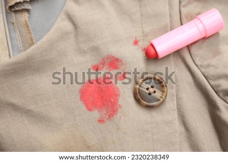 Dirty lipstck stain on cloth from using in daily life. stain for cleaning concept idea. Royalty-Free Stock Photo #2320238349