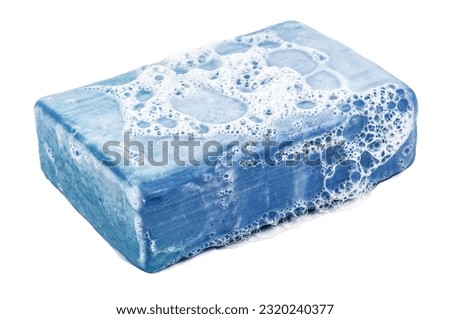 Piece of blue soap with sud foam isolated on white background Royalty-Free Stock Photo #2320240377
