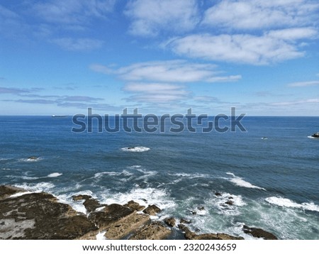Aerial view of waves crashing onto the rocky coastline of Dunbar Scotland. 