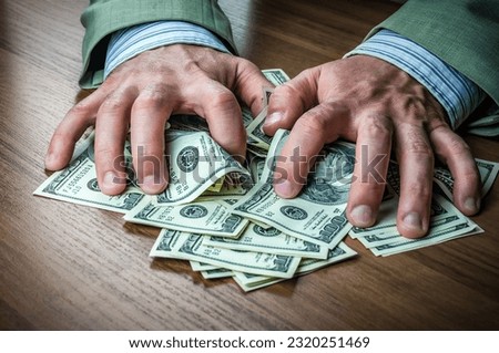 Concept for corruption, finance profit, bail, crime, bribing, fraud, auction bidding. Bundle of dollar cash in hand. man takes the bribe Royalty-Free Stock Photo #2320251469