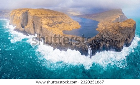 A helicopter view of "Sørvágsvatn" which is the largest lake in the Faroe Islands. It is situated on the island of Vágar between the municipalities of Sørvágur and Vágar. Royalty-Free Stock Photo #2320251867