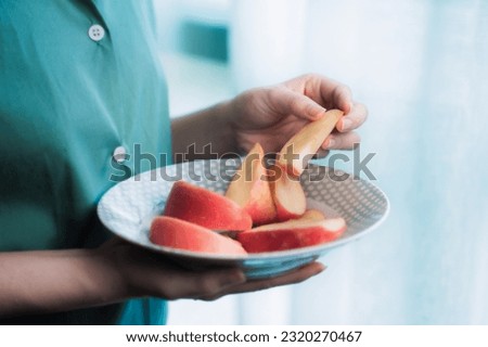 close up asian woman eating red apple keep for health at home.
Organic Fresh Fruits for a Healthy.
Diet and healthy food concept. Royalty-Free Stock Photo #2320270467