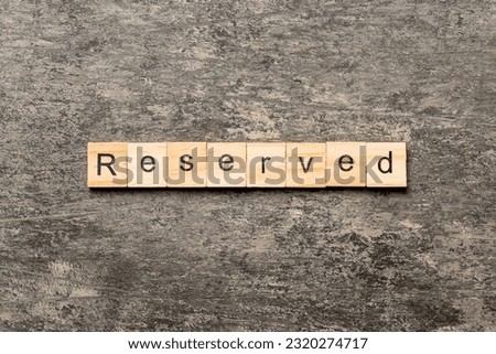 reserved word written on wood block. reserved text on cement table for your desing, concept.