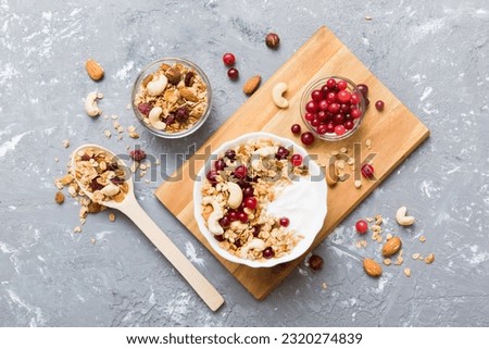 Healthy breakfast food with granola, yogurt, fruits and nuts. Dessert parfait with dried fruits for breakfast. Royalty-Free Stock Photo #2320274839
