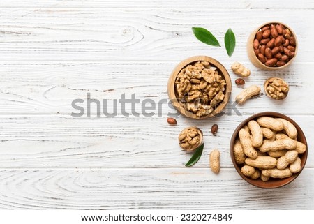 Walnut kernel halves, in a wooden bowl. Close-up, from above on colored background. Healthy eating Walnut concept. Super foods with copy space. Royalty-Free Stock Photo #2320274849