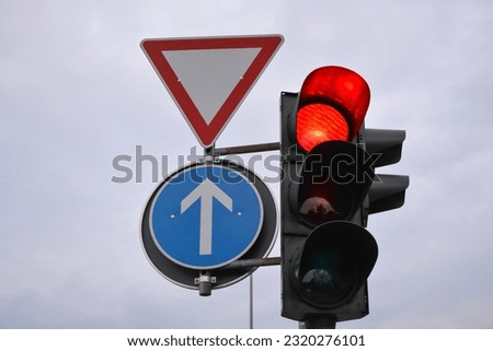 Traffic control signs and traffic light with red prohibitory color on the sky background on the road pole. Car traffic management