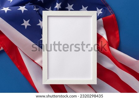 American federal holiday concept. High angle view photo of rectangular wooden frame on american flag on blue isolated background with copy-space