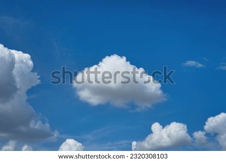 The fluffy clouds and blue sky