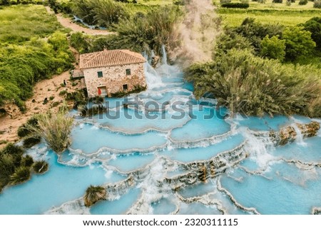 Toscane Italy, natural spa with waterfalls and hot springs at Saturnia thermal baths, Grosseto, Tuscany, Italy. Aerial view. Natural thermal waterfalls at Saturnia Toscany Royalty-Free Stock Photo #2320311115