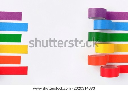 Multicolored rolls of rainbow adhesive tape on the side on a white background.A set of bright sticky decorative ribbons for creativity, packaging in gift boxes, for making postcards.Copyspace Royalty-Free Stock Photo #2320314393