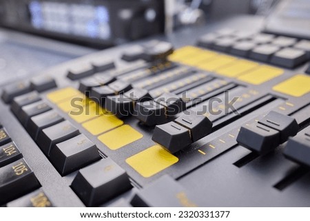 Man hands of sound engineer adjusting audio mixing console