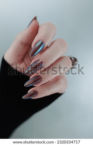 Beautiful woman's hand with long nails and multicolored nail polish Royalty-Free Stock Photo #2320334717