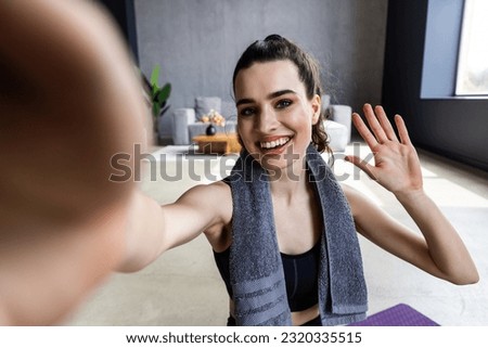Young woman doing self portrait on yoga mat. Home vacation indoors portrait.Alone in interior. Happy emotion. Smiling female person. Lifestyle action. Posing influencer