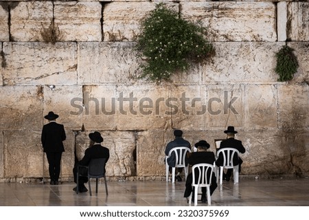 Jewish religious praying in front of the wailing wall in Jerusalem. Royalty-Free Stock Photo #2320375969