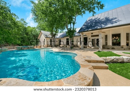 A home back yard with a swimming pool  Royalty-Free Stock Photo #2320378013