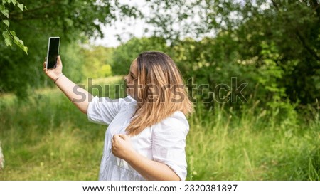 girl in the park taking a selfie