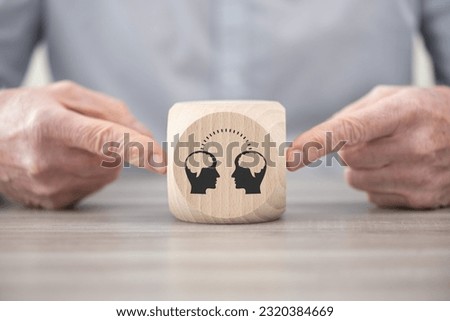 Wooden block with symbol of knowledge sharing concept Royalty-Free Stock Photo #2320384669