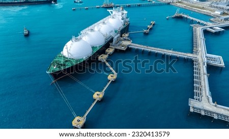 LNG (Liquified Natural Gas) tanker anchored in Gas terminal gas tanks for storage. Oil Crude Gas Tanker Ship. LPG at Tanker Bay Petroleum Chemical or Methane freighter export import transportation  Royalty-Free Stock Photo #2320413579