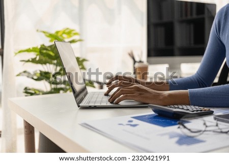 Businesswomen use charts, charts, and laptops to analyze market data, balance sheets, accounts, and net profit to plan sales strategies and increase production capacity and export. Remote Picture