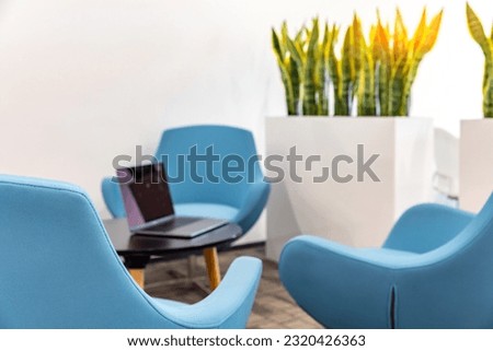 Corporate interior lounge area with round tables and chairs 