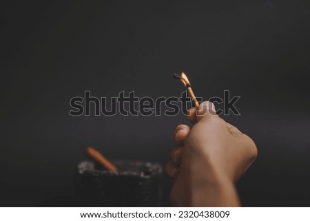 Burning lighting matches at the moment when it explodes over black background
