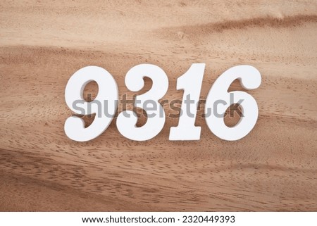 White number 9316 on a brown and light brown wooden background.