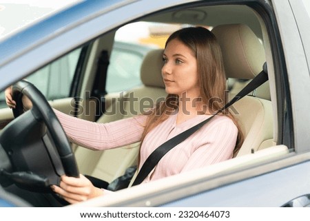 Young pretty blonde woman inside a car