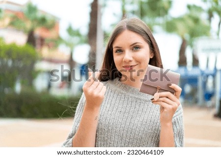 Young pretty blonde woman holding wallet with money gesture Royalty-Free Stock Photo #2320464109