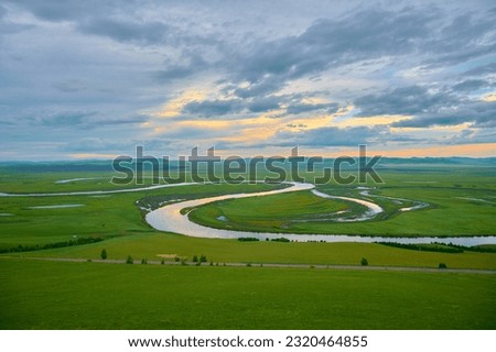 The river and hills in the summer grassland of Hulunbuir,Evening sky,sunset glow, wiggling river Royalty-Free Stock Photo #2320464855