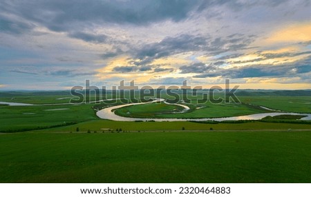The river and hills in the summer grassland of Hulunbuir,Evening sky,sunset glow, wiggling river Royalty-Free Stock Photo #2320464883