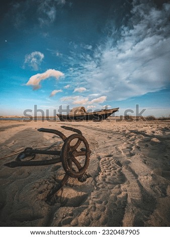 A boat anchor on a beach and beautiful blue sky with background 