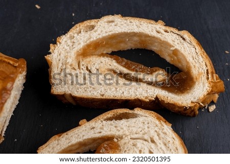 sliced soft fresh wheat pastries with golden crust, cut delicious fresh and soft pastries with jam filling Royalty-Free Stock Photo #2320501395