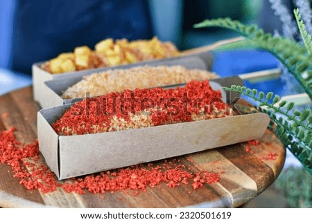 Different types of Korean style corn dogs coated in crispy panko breadcrumbs or potato slices with seasoning Royalty-Free Stock Photo #2320501619