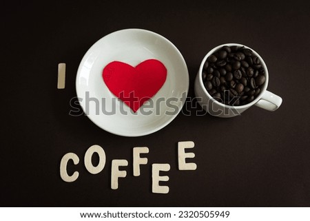 I Love Coffee concept background design flat lay image of coffee beans in a white cup with red heart shape