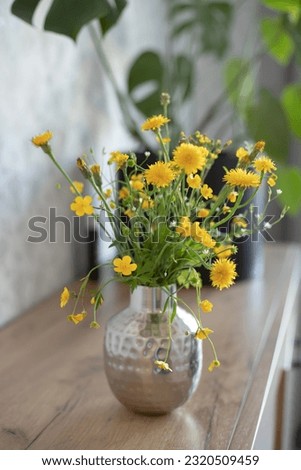 Fresh yellow wildflowers in home interior