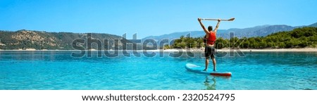 SUP Stand up man with paddle on lake in France (Verdon)