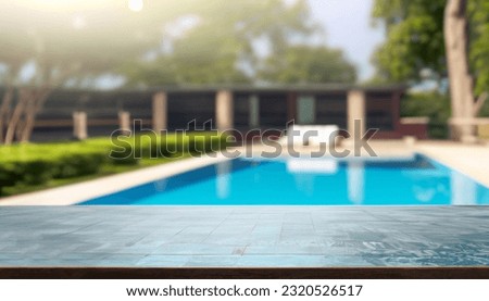 Empty wooden table in front with blurred background of swimming pool Royalty-Free Stock Photo #2320526517