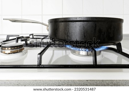 non-stick coated pan on gas stove Royalty-Free Stock Photo #2320531487
