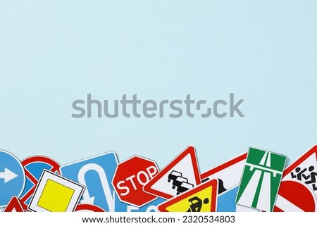 Driving school banner template. Many different road signs on light blue background.