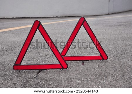 A safety triangle that is installed on a road, as a sign that there is an emergency ahead in that area