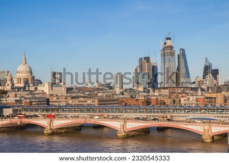 London cityscape featuring St Paul's Cathedral and skyscrapers on a cloudless day in England