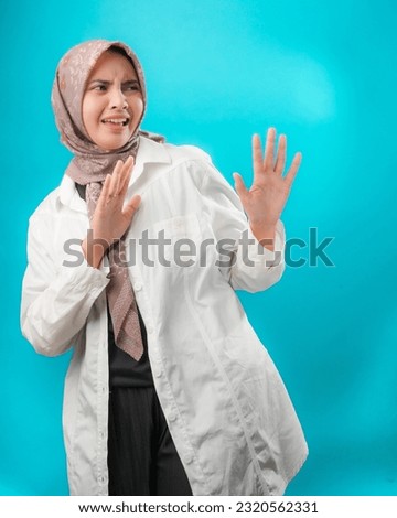 Potrait Beauty Indonesian Girl Refuse Something that is Given from Right Royalty-Free Stock Photo #2320562331