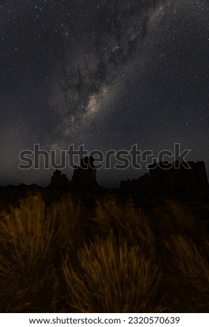 Night time long exposure landscape photography. high place looking up in wonder to the Milky Way galaxy, photo composite.
