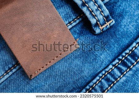 Blue Denim Jeans,belt,jeans pants with leather belt.label,sticker,tab,tag on the jeans.Empty blank space.closeup.Mockup.Copy space.