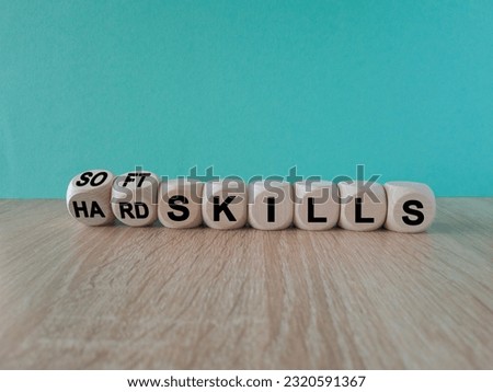 Hard skills versus soft skills. Dice form the expressions hard skills and so ft skills. Beautiful blue background. Wooden table, Business concept. Copy space. Royalty-Free Stock Photo #2320591367