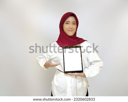 Young woman holding her device making a promotion advertisement concept