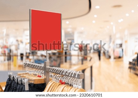 red blank sign inside shopping mall. mock up advertise display frame setting over the clothes line in the shopping department store for shopping, business fashion and advertisement concept.