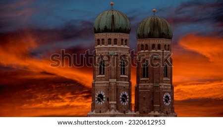 The two towers of the Frauenkirche in the old town of Munich against dramatic, colorful evening sky with light to medium cloud cover Royalty-Free Stock Photo #2320612953
