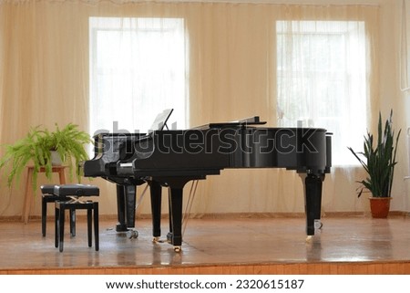 Black piano in bright music room